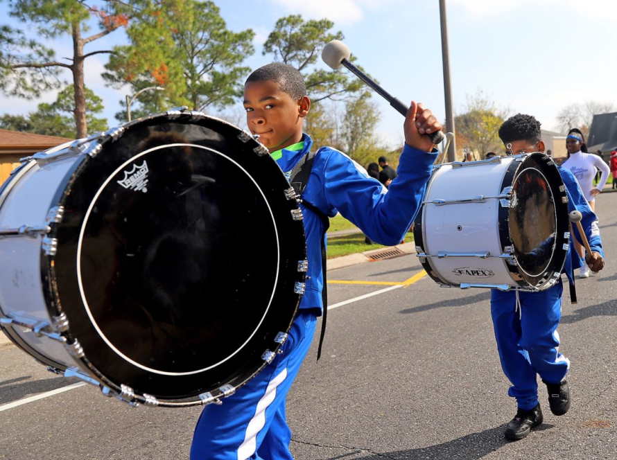 Young drummers marching through New Orleans East